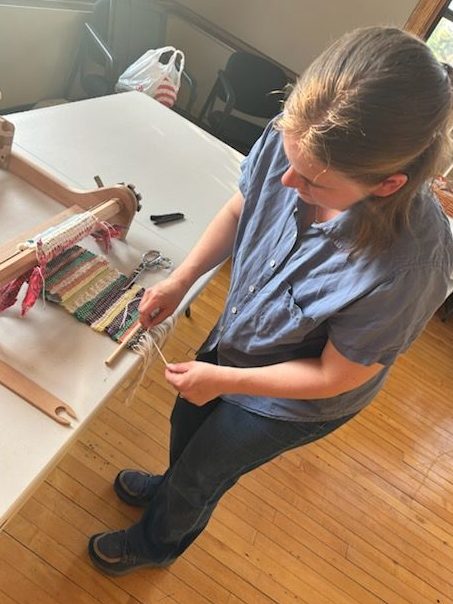 Shara binding the edge of the Community Weave project