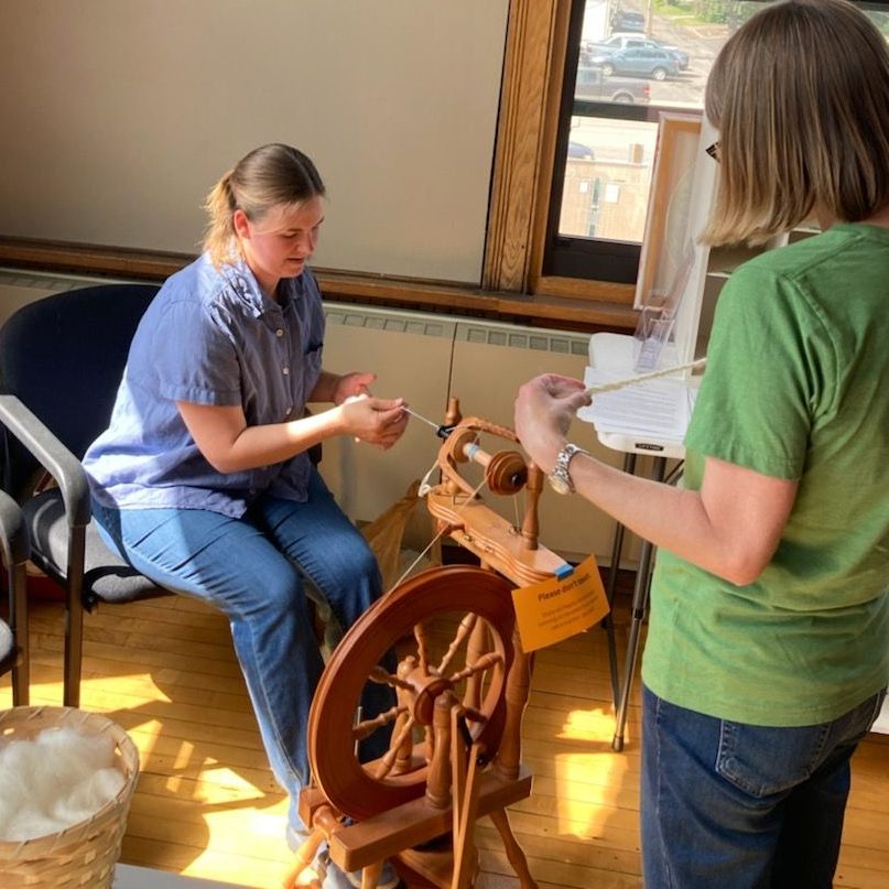 Shara spinning yarn and explaining the process