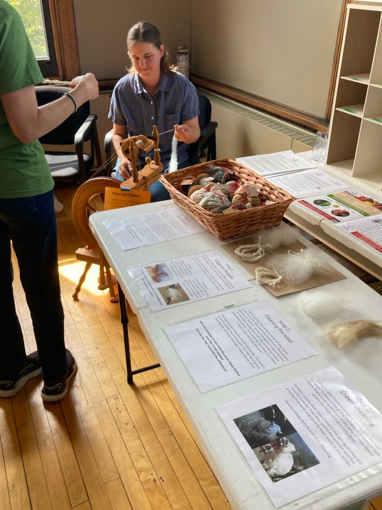 Fiber preparation table with Shara spinning yarn in the background