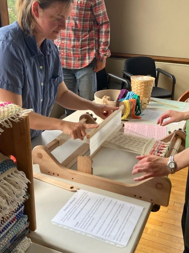 Shara teaching the weaving process